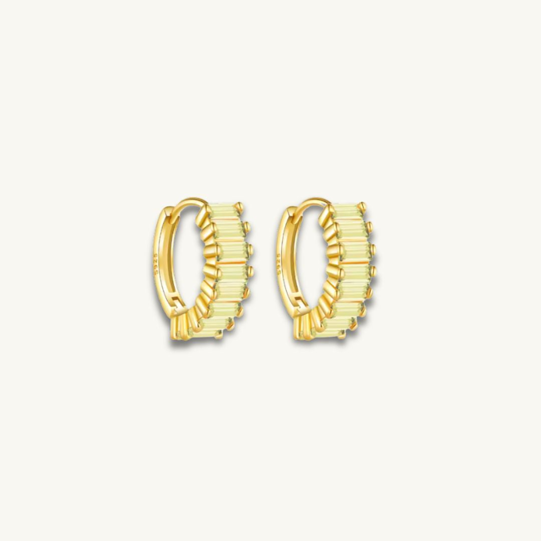 gold huggie earrings with green baguette stones