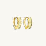 gold huggie earrings with green baguette stones