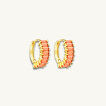 gold huggie hoop earrings featuring orange baguette stones