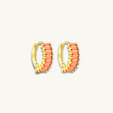 gold huggie hoop earrings featuring orange baguette stones