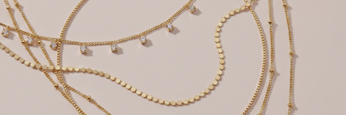 Gold layering necklaces worn by a women