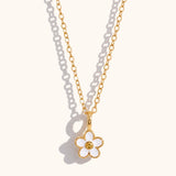 gold necklace with white enamel daisy pendant