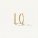 Gold hoop earrings with embedded diamonds on a light gray background