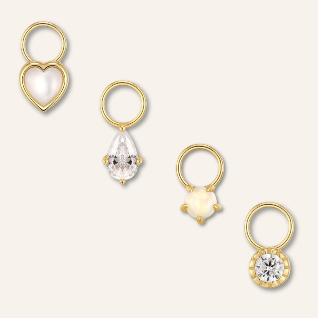 Luxurious 14k gold vermeil earring charms featuring opal gemstones, cubic zirconia, and mother of pearl. A captivating ensemble of elegance and opulence.