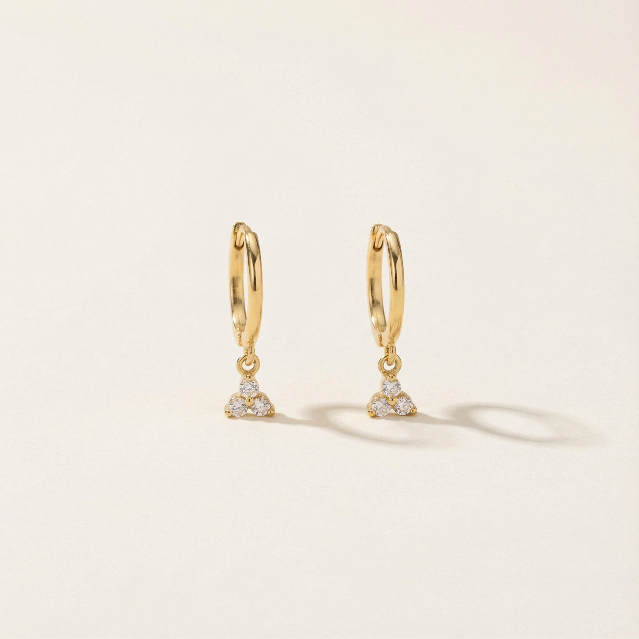 14k old dangle hoops with three cubic zirconia stones