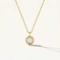 14k Solid Gold necklace with a pendant featuring an opal stone on a white background