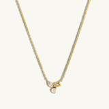Gold necklace with a pendant on a white background