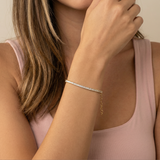 Close-up of a person wearing a baguette tennis bracelet