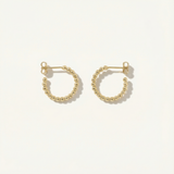 Gold hoop earrings on a white background