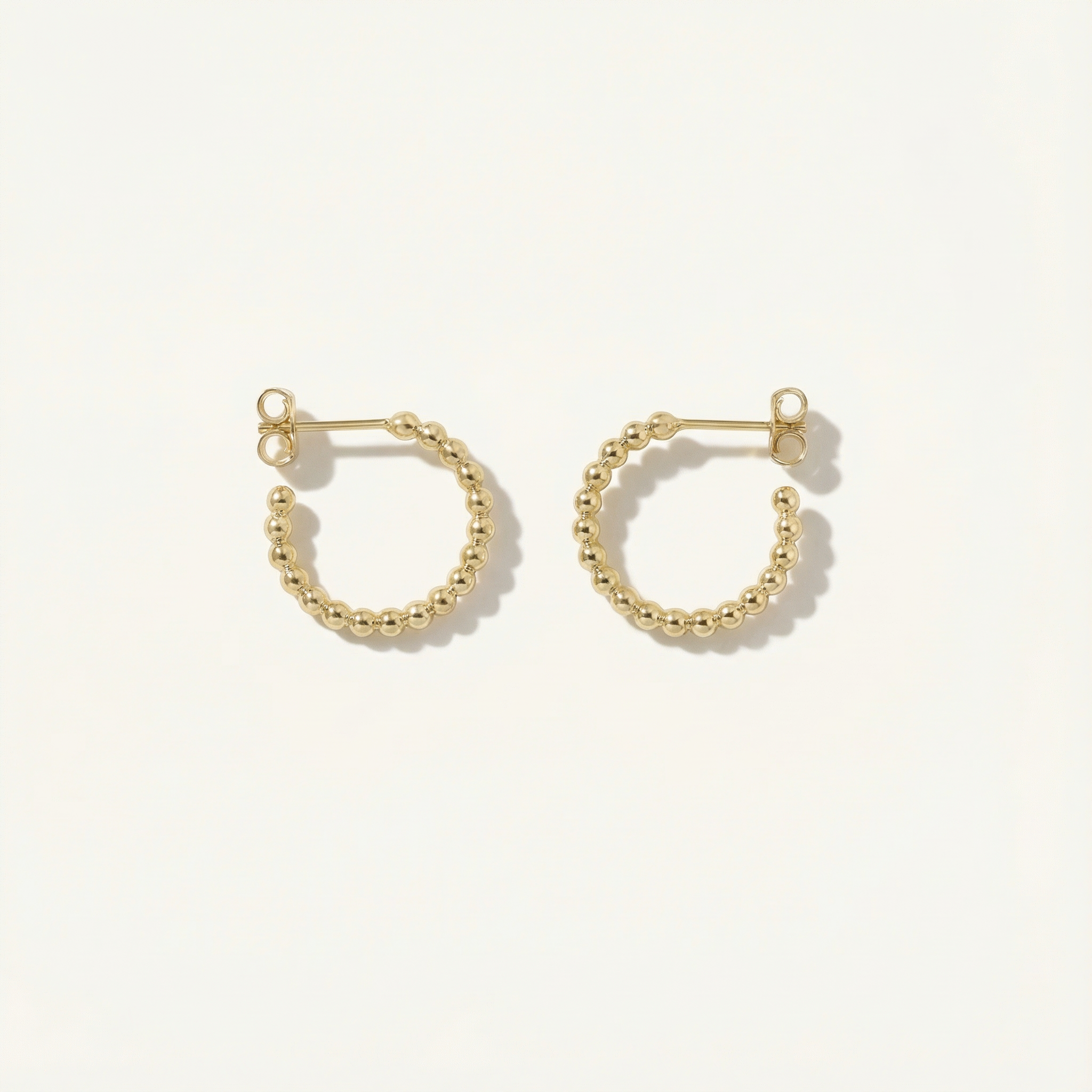 Gold hoop earrings on a white background