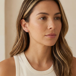 a women wearing gold hypoallergenic jewelry