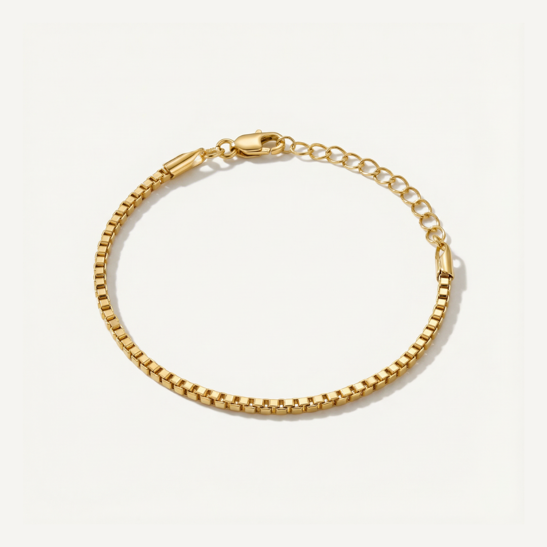 Gold box chain bracelet on a white background