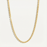 Gold chain necklace on a light gray background