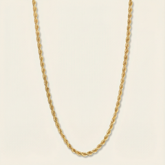 Gold rope chain necklace on a beige background