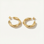 Gold hoop earrings on a white background