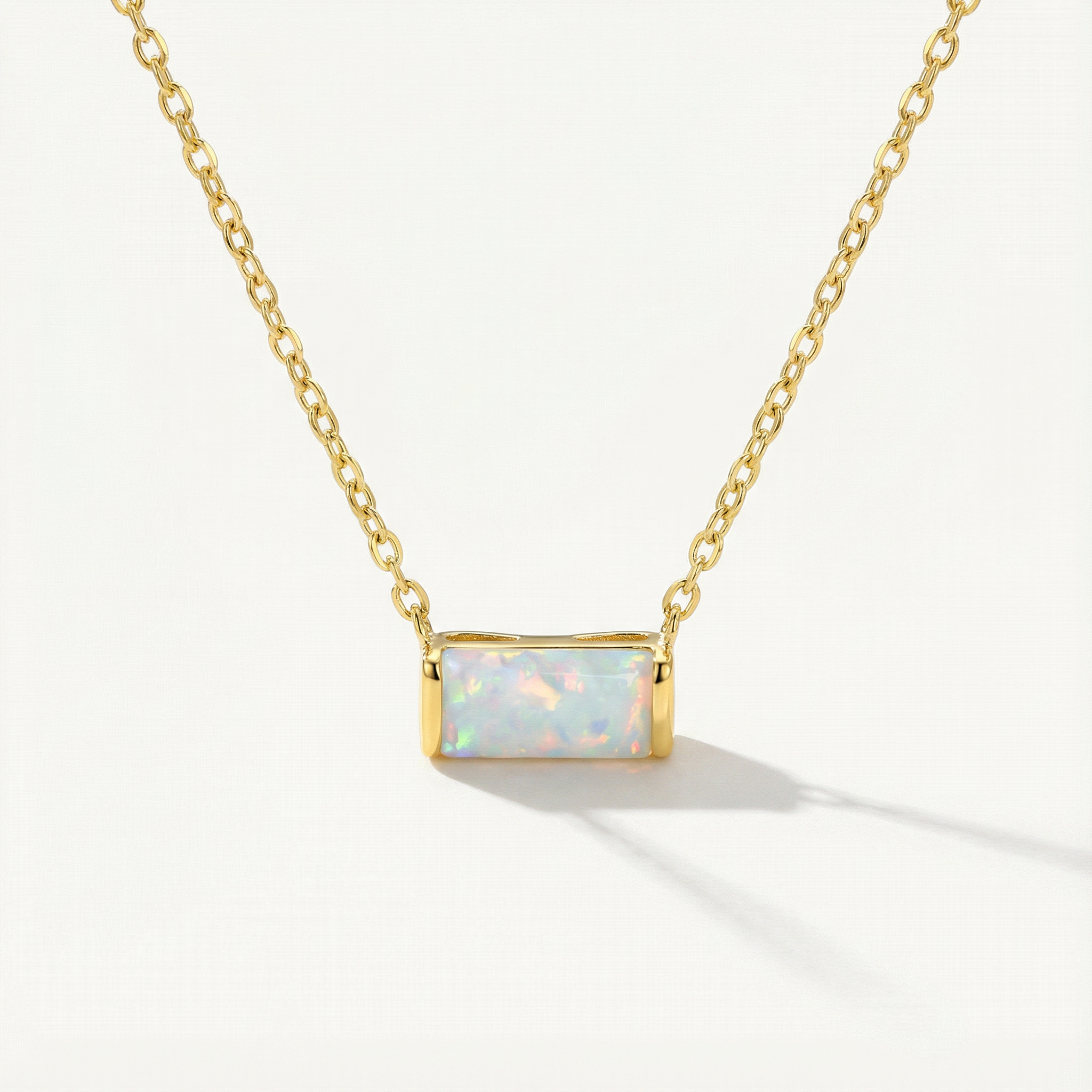 gold opal necklace against a white background
