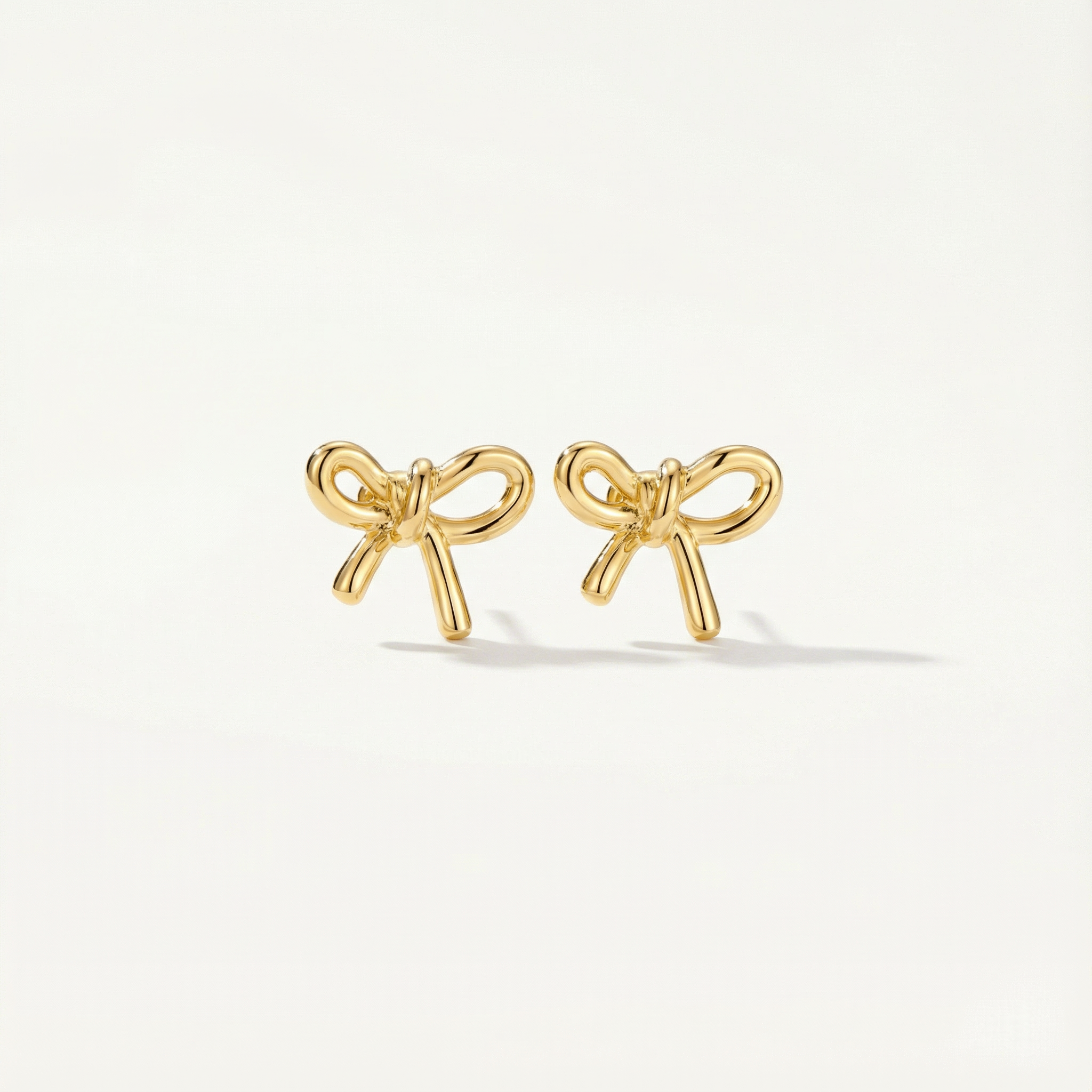 gold bow stud earrings