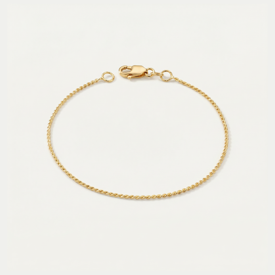Gold dainty bracelet on a light beige background