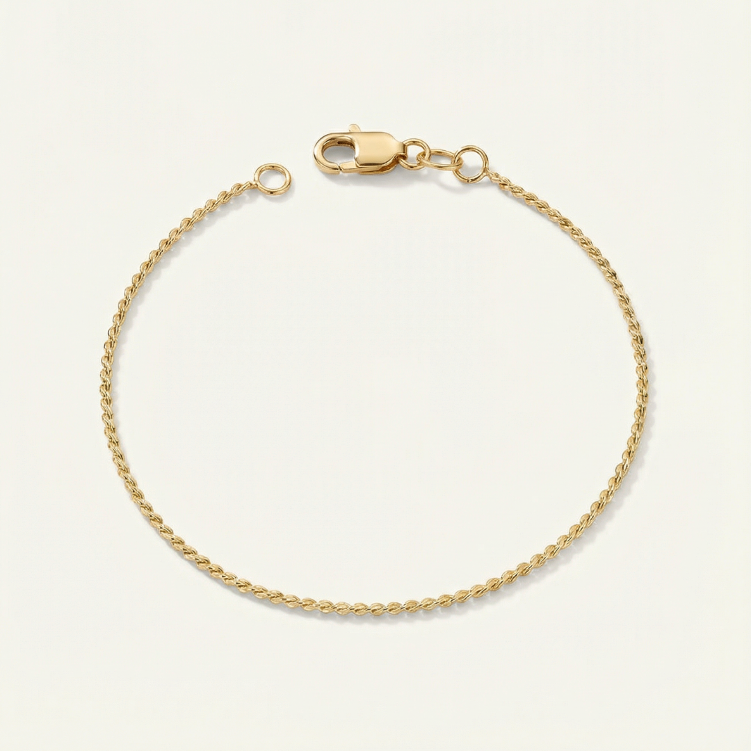 Gold dainty bracelet on a beige background