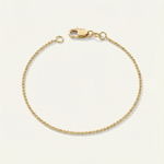 Gold dainty bracelet on a beige background
