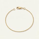 Gold dainty bracelet on a beige background