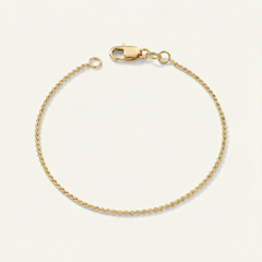 Gold dainty bracelet on a beige background
