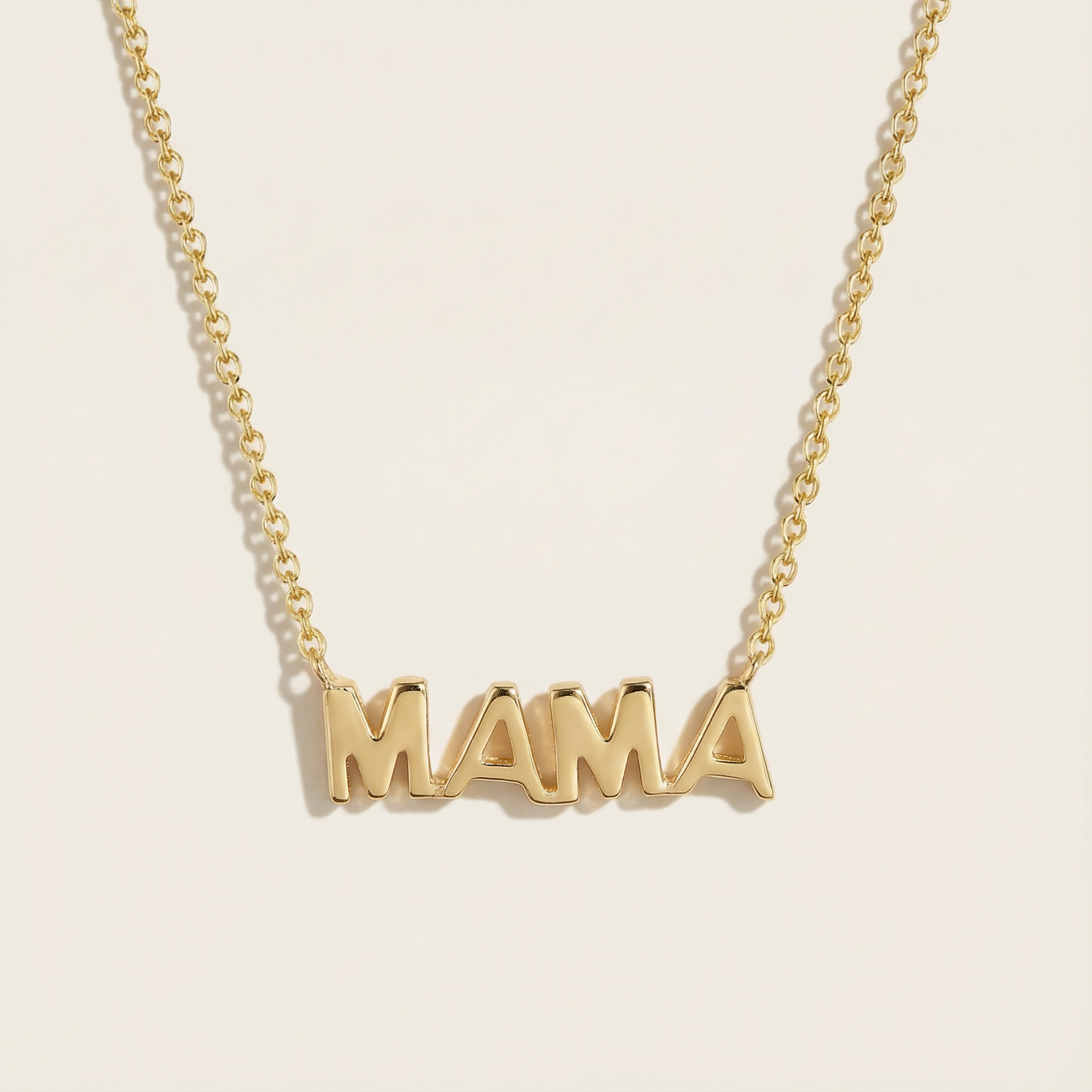 Gold Mama Necklace against a neutral background