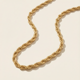 18 Gold rope necklace on a beige background