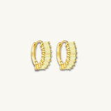gold huggie earrings with green baguette stones
