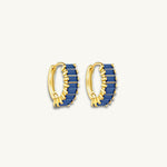 gold huggie earrings featuring navy blue baguette stones