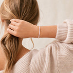 pink tennis bracelet worn by a women